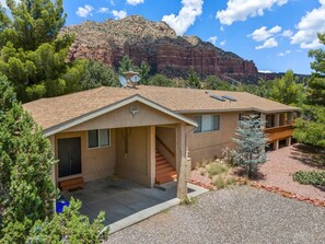 The entrance to the home, with beautiful red rocks in the background