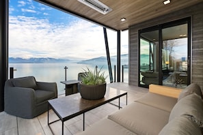 The private patio enjoys comfortable furniture and overhead, infrared heat.