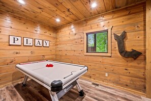 Fun-filled game room featuring air hockey table, perfect for friendly competition
