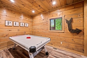 Fun-filled game room featuring air hockey table, perfect for friendly competition