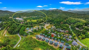 A peaceful neighborhood nestled in lush hills, close to modern conveniences.