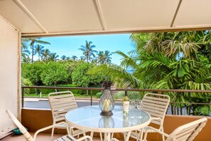 Surrounded by lush palms and island greenery, this cozy lanai is perfect for sipping wine and soaking up the aloha breeze     MKV-C255