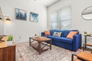 You feel at home as you settle into the living room, where the inviting atmosphere is perfect for lounging or entertaining.