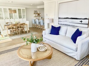 Light, bright open floor plan, wide plank floors, modern coastal decor.