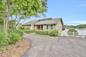 Inviting front lawn with panoramic lake views.