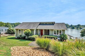 Front elevation featuring a serene lawn that effortlessly transitions to the peaceful waters of the lake.
