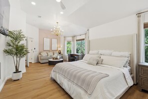 spacious master bedroom with a king bed and private bathroom on the second floor