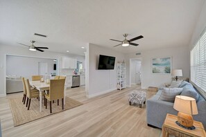 Open floor plan is perfect for families with a large dining table in the center and two living areas on each side
