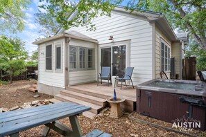 Backyard area with deck, picnic table and hot tub!! Landscaping happening soon!