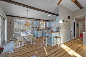 Full sized kitchen with bench and stool seating. Fully stocked with coffee, tea, creamer, condiments and seasoning. Paper goods and pots, pans, plates, bowls and coffee mugs as well as wine glasses.