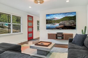Entertainment central: 85" 4K QLED TV with provided cable and local channels via YouTube TV.