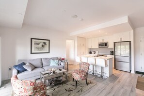 Modern open concept living space featuring a cozy sofa bed