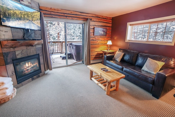 Living Room with Gas Fireplace Sliders to Deck