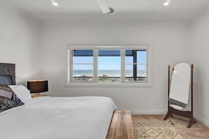 The second bedroom also boasts tranquil water views and a ceiling fan for added comfort.