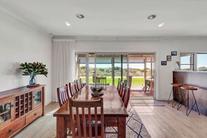 Share meals in the open-plan dining area, where you’ll find an eight-seater table setting as well as additional seating at the breakfast bar. 
