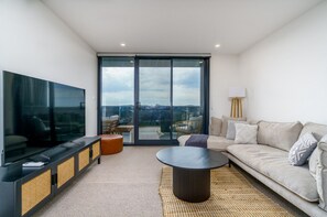 Relax in our comfy lounge featuring a TV and stunning views. It’s the perfect spot to unwind after a day of exploring or simply enjoy a movie with a beautiful backdrop.