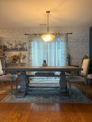 Dining table w/ long bench to seat at least 5 people at the table.