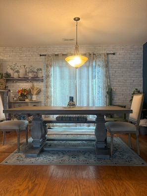 Dining table w/ long bench to seat at least 5 people at the table.