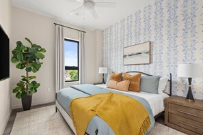 Spacious bedroom with modern decor and TV