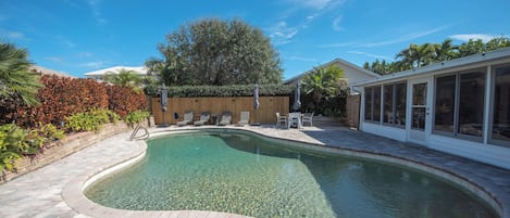 Relaxing patio with heated pool. Hear the waves crashing from the backyard!