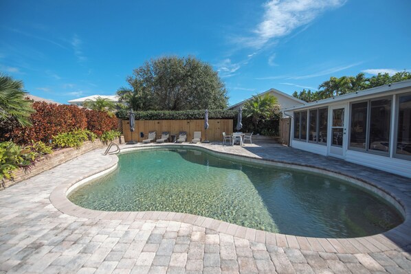 Relaxing patio with heated pool. Hear the waves crashing from the backyard!