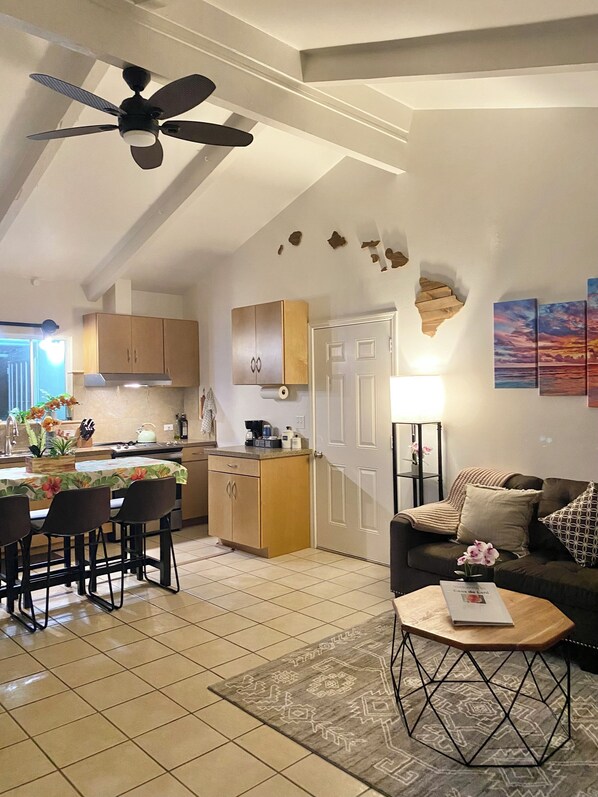 Open concept kitchen and living room with vaulted ceiling.