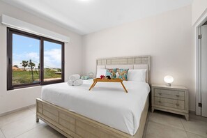 A cozy room with white and green pillows.