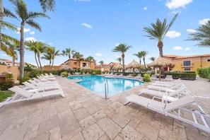 Swimming pool surrounded by pool chairs.