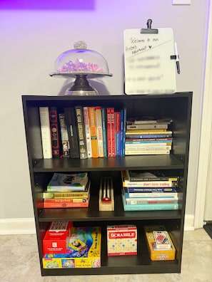Book shelf with fantastic reads, board games and puzzles for your stay