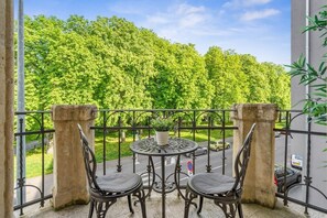 Step out onto a charming balcony and savor stunning green views, the perfect spot for your morning coffee.