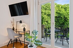 Comfortable bedroom with direct access to a balcony and a wall-mounted TV for your entertainment.