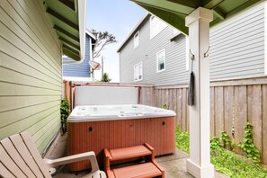 Spacious hot tub fenced for privacy, kept at a warm 104 degrees