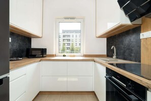 Separate kitchen with microwave.