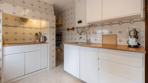 Fully equipped kitchen with a traditional Portuguese touch. Easily prepare delicious meals in comfort. #airbnb #lisbon #vacations