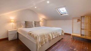 Cozy and bright bedroom with a comfortable queen bed and slanted ceiling. Relax under the skylight and enjoy a peaceful night’s sleep. #pt #airbnb #apartment