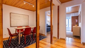 Elegant dining area with vibrant chairs and a light wood table, creating a warm atmosphere for meals with friends or family. #lovely #home #vacations #airbnb