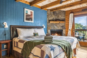 The upstairs primary suite features a king sized bed and attached bathroom.