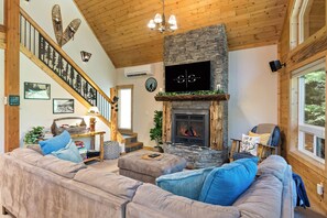 Unwind on plush sofas by the stone fireplace, high ceilings & flat-screen TV.