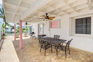 Covered Patio | Gas Grill | Outdoor Dining Area | Canal Access