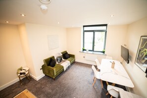 "Cozy living room with comfortable seating and natural light."