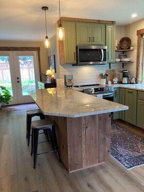 Full kitchen with large fridge and eating bar