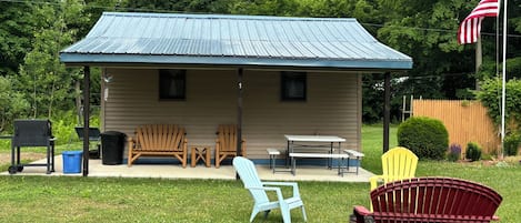 Private covered porch with seating, bbq grill, firepit, yard games. Relax/Play!