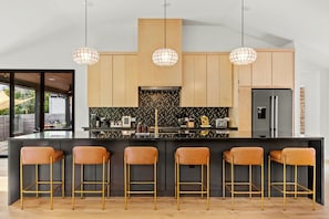 Fully stocked kitchen, breakfast bar with seating for 6 people.