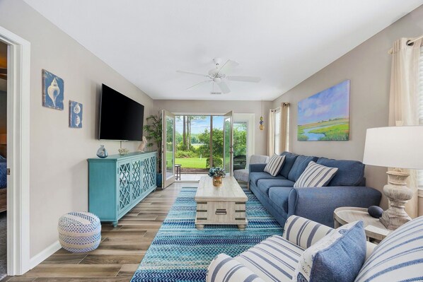 Sunny living, lake and garden views, comfy coastal furnishings, 65" flatscreen.