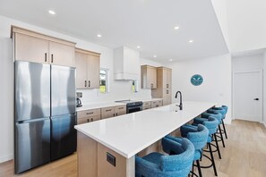 Have a few drinks at the kitchen island while watching the designated chef in action.