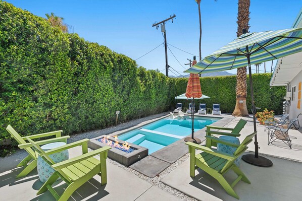 Backyard oasis with ample outdoor seating and firepit 
