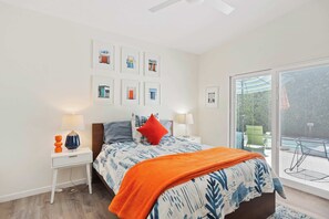 Bedroom 1 with king bed, Smart TV, and patio access 