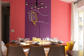 Gather around the colorful dining space, perfect for sharing delicious meals.