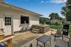 4 roll up window indoor outdoor bar view of hills, hot tub and outdoor seating area