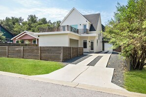 This charming two-story house, painted in pristine white, exudes a classic, welcoming appeal.